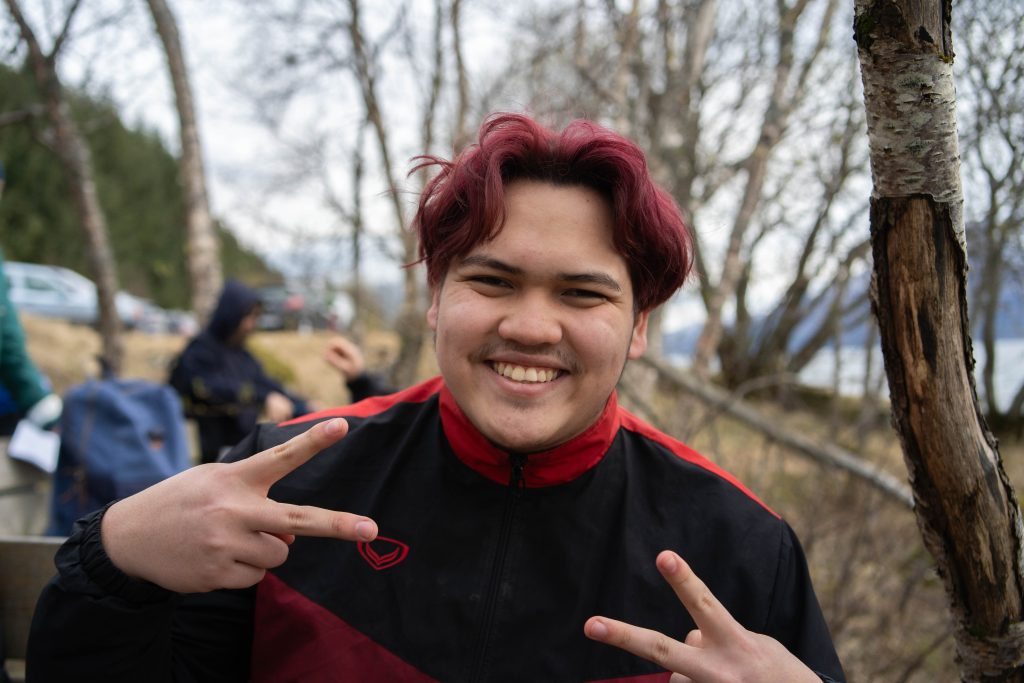 Elev som smiler og viser peacetegn